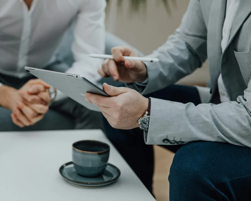 Two professionals reviewing geospatial project on a tablet — OnTerra Systems web mapping consulting and software development services